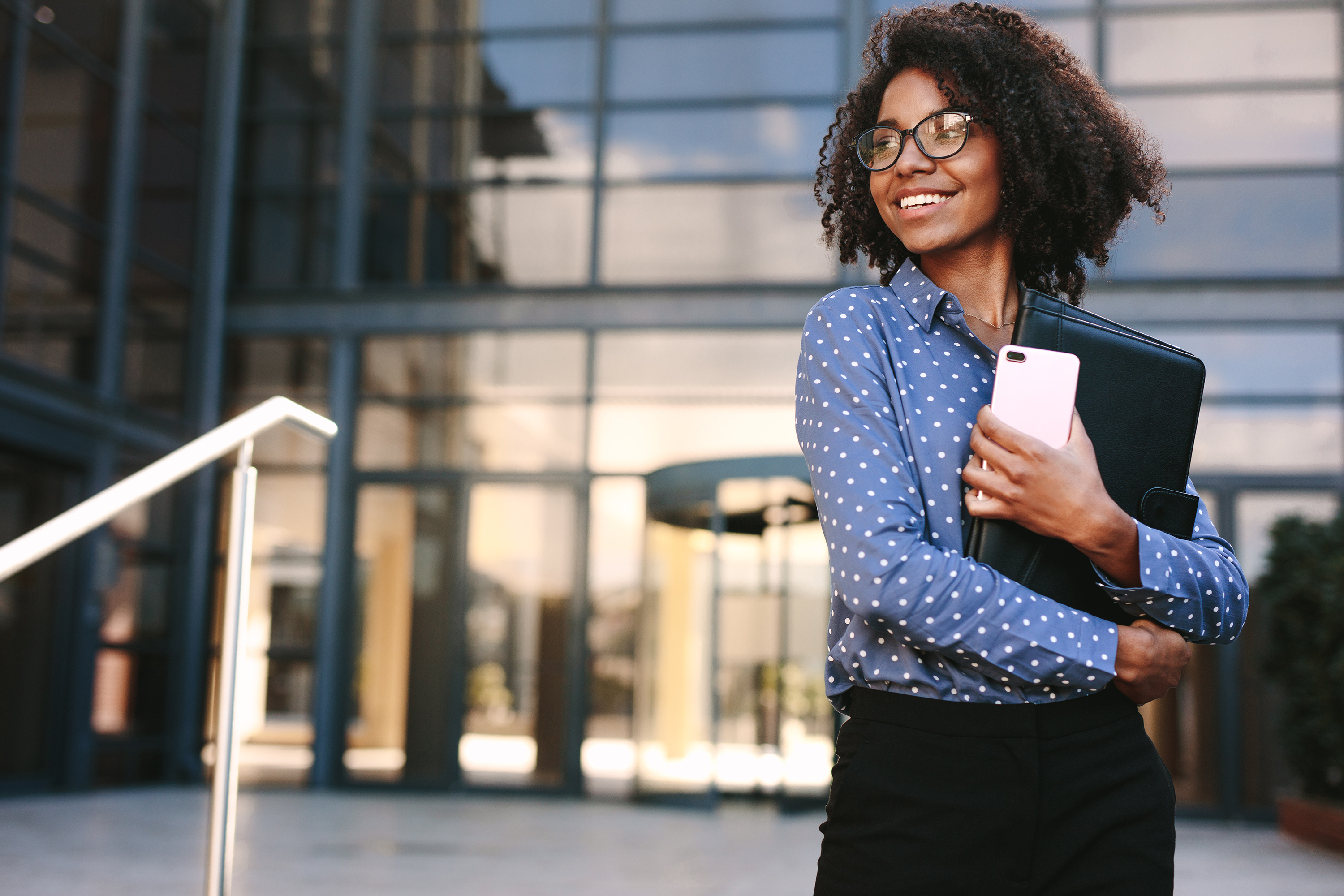 Young Woman in front of Office Building
