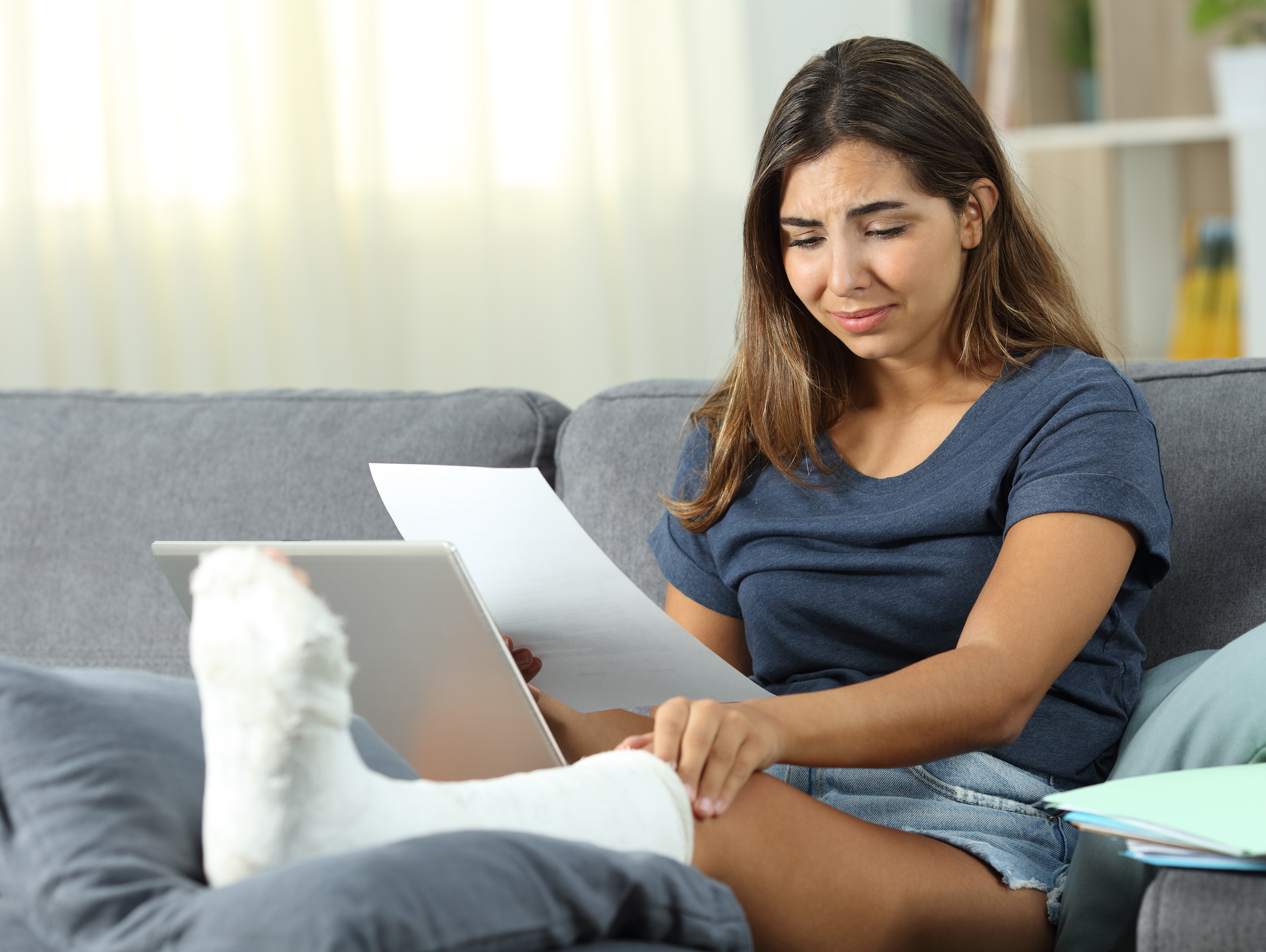 Woman Sitting on Couch with Leg Propped Up