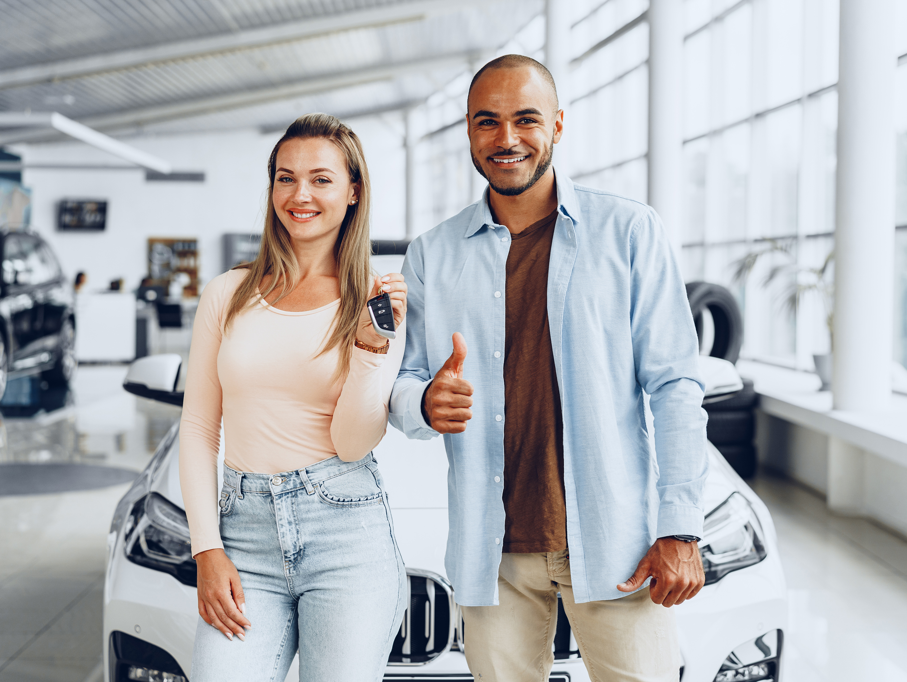 Couple with Key to Car in Dealership