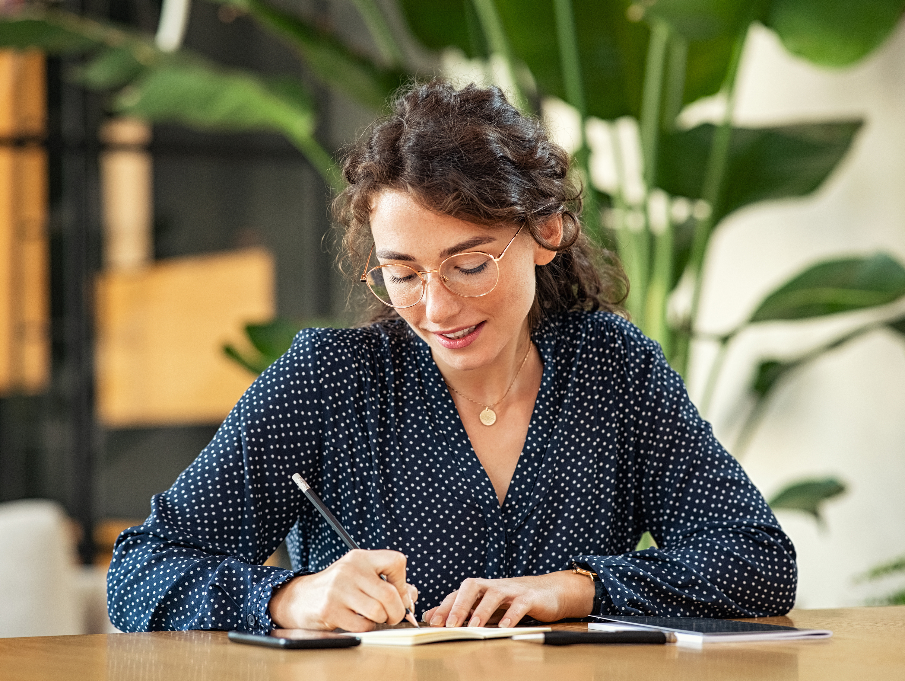 Woman Writing in Notebook