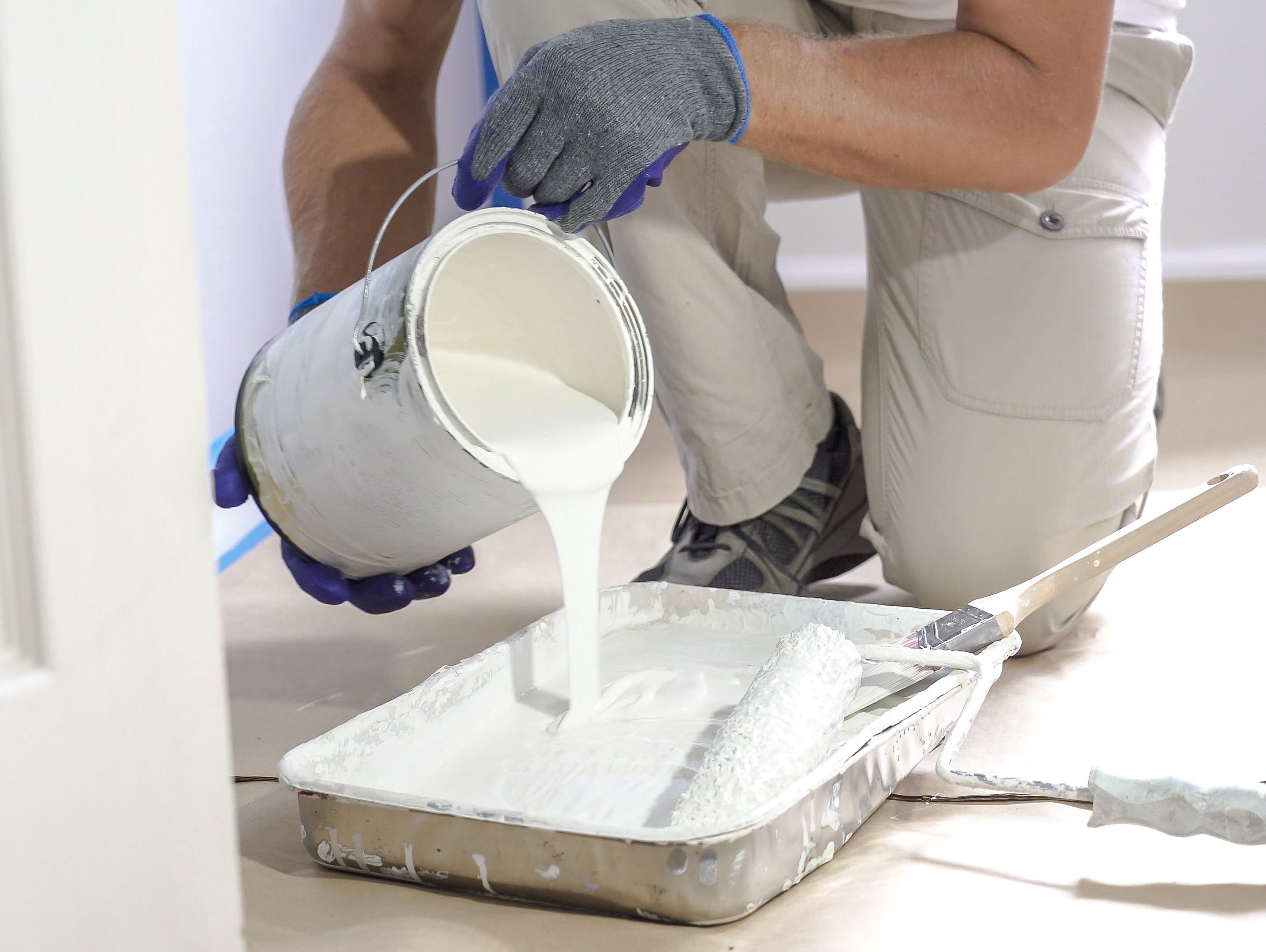 Painter Pouring Paint in Pan